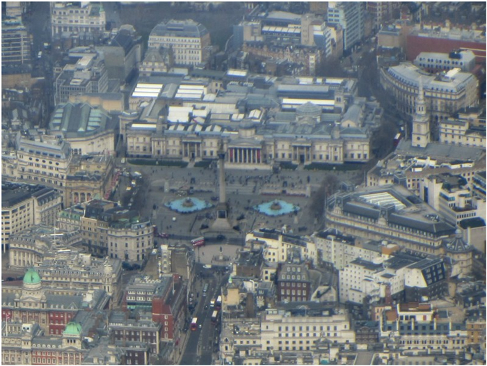 Трафальгарская площадь(Trafalgar Square). В центре –  колонна Нельсона (Nelson's Column), позади -  Национальная картинная галерея, справа - церковь св. Мартина в полях (St Martin-in-the-Fields), среди её прихожан – королевская семья.